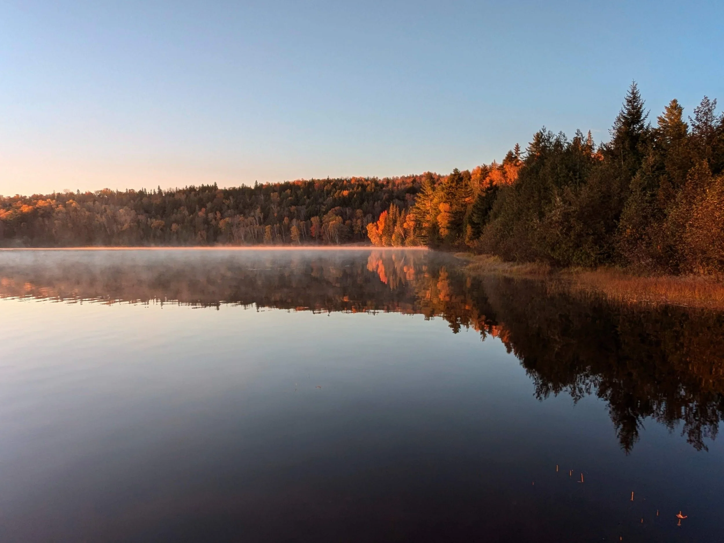 October sunrise, sea smoke rising.