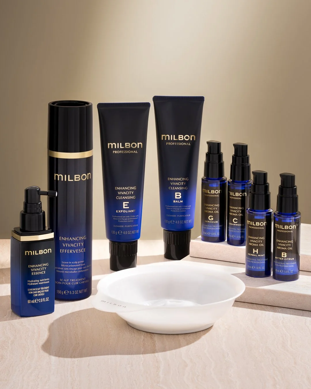 Collection of Milbon professional hair care products, including cleansing, essence, and aroma oils, arranged on a white surface with a small white dish in front.