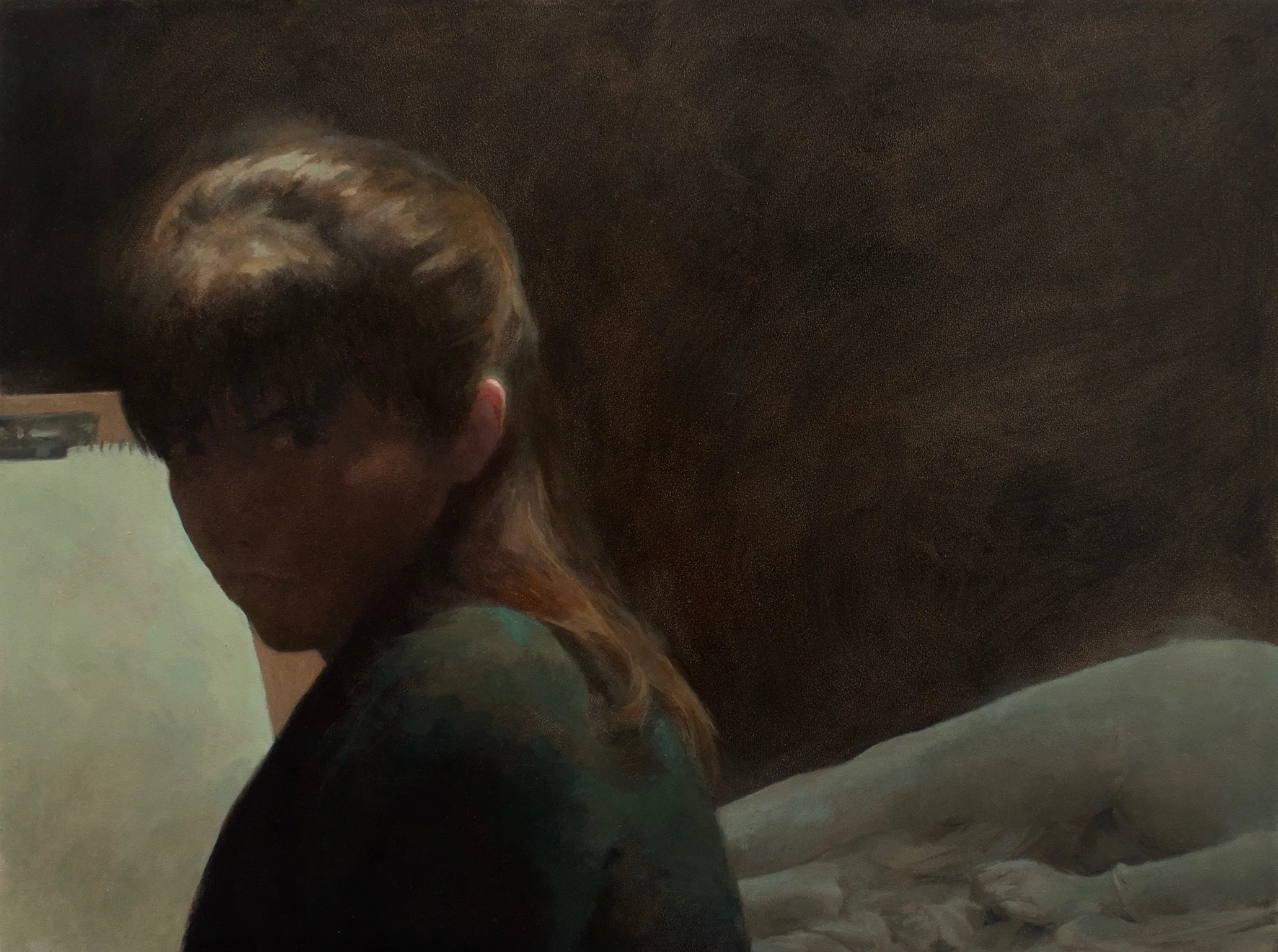 A young woman glaring in front of a drawing pad, set against a dark background, with light illuminating part of her hair and shoulder.