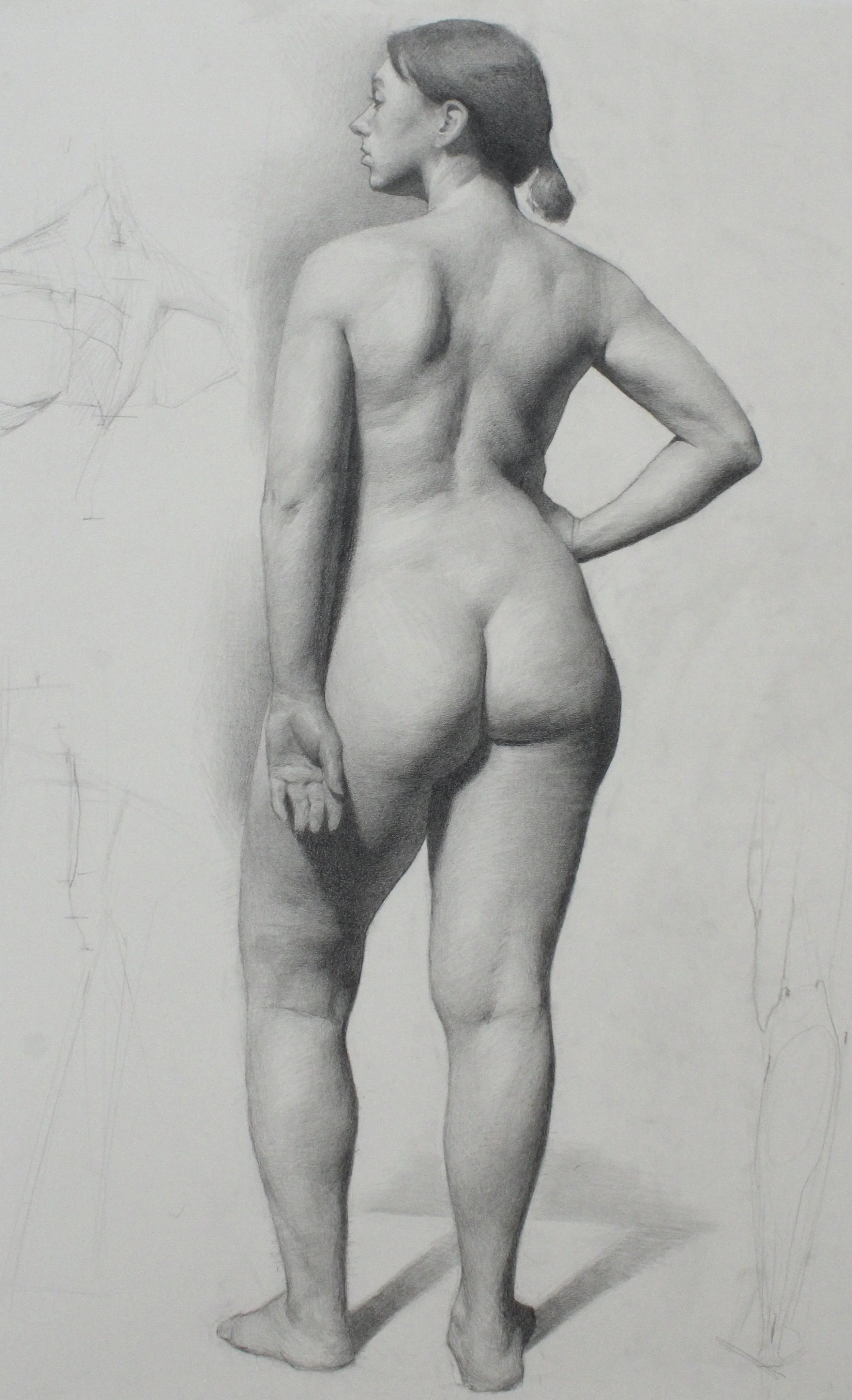 Detailed graphite drawing of a nude woman standing with her back turned, one hand on her hip and her head turned to the side.