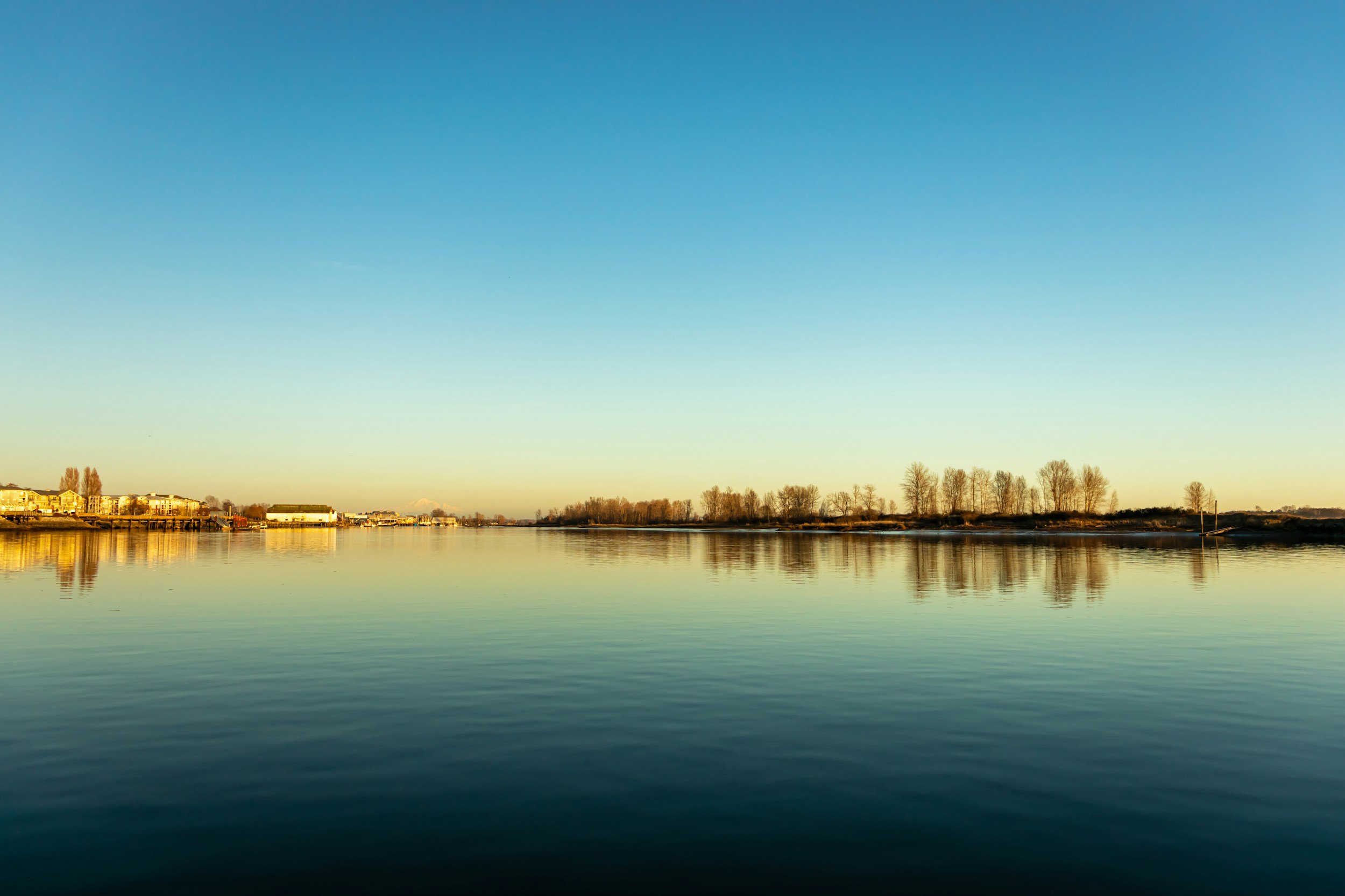 Richmond river reflection on the water during sunset against cloudless blue skies