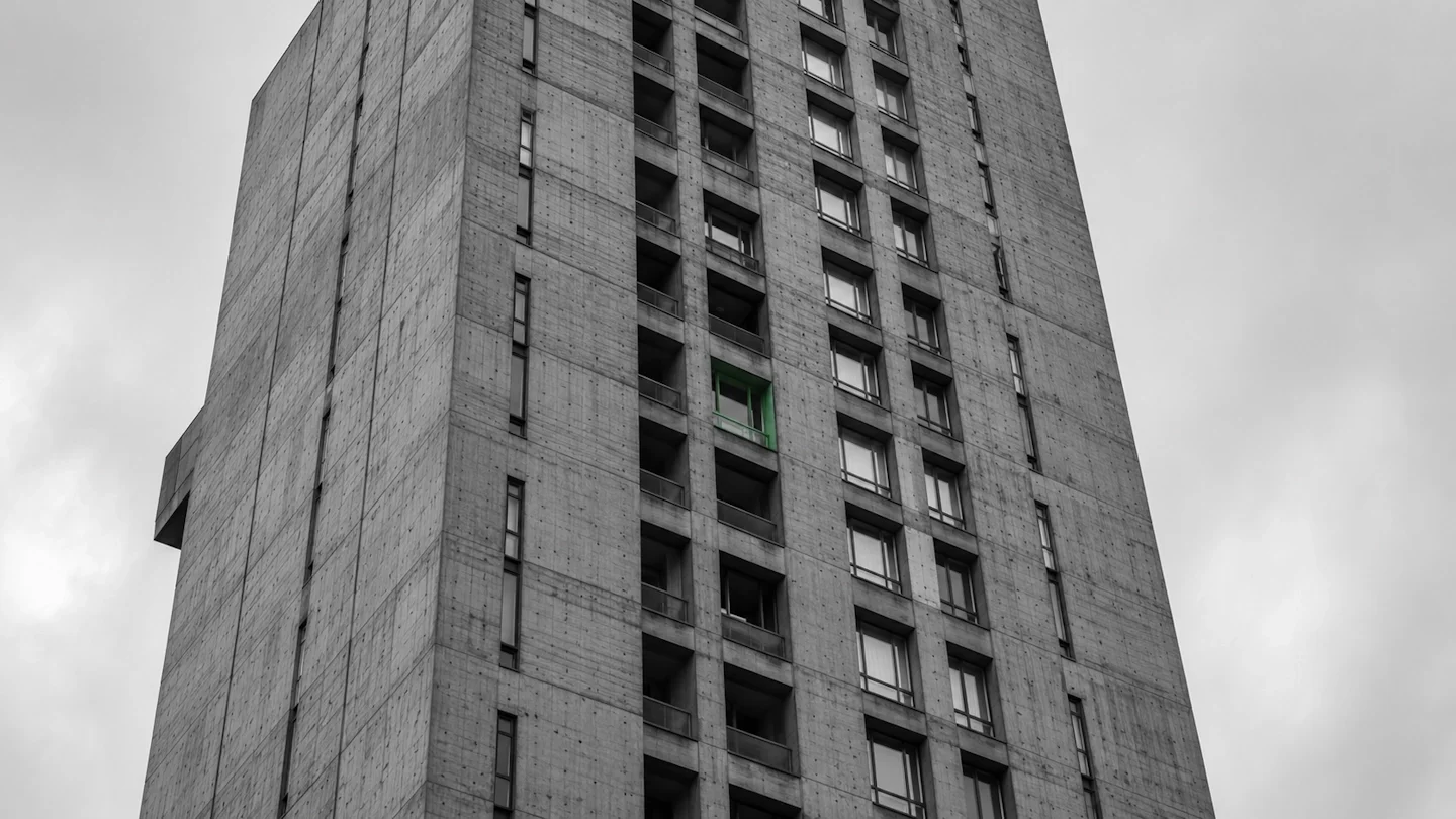 Towering brutalist concrete tower with grid of windows — AI maturity diagnostic for small businesses