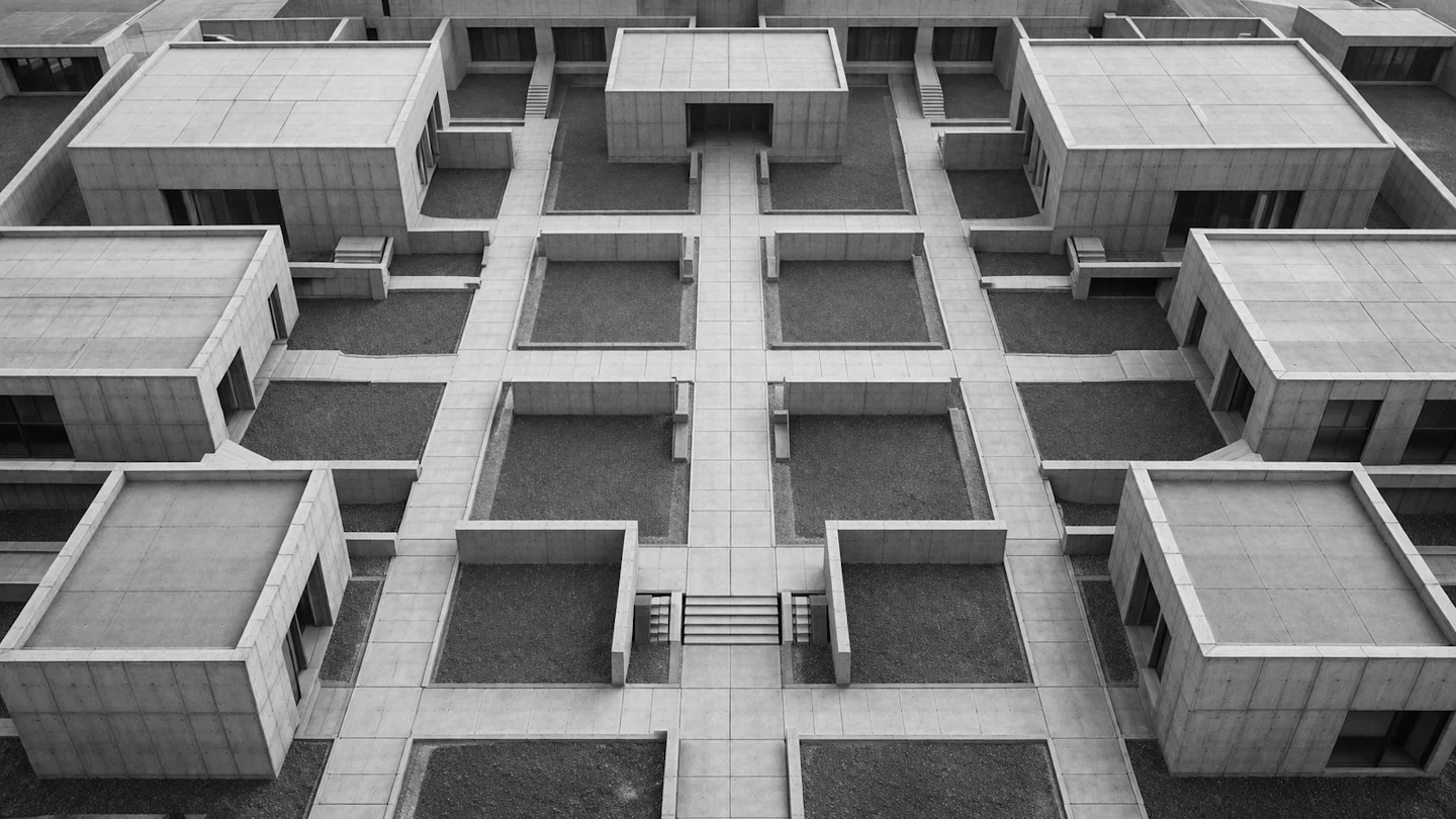 Aerial view of a connected modular concrete complex with geometric pathways linking separate blocks — why every growing business needs a business operating system.