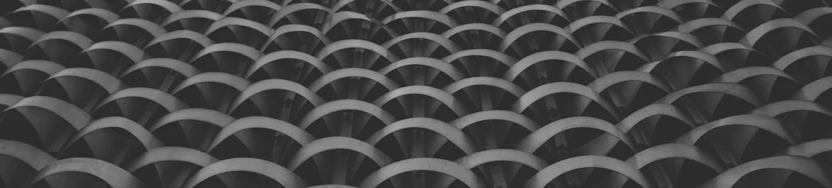 Repeating curved concrete forms in shadow — get in touch with GrowthPains