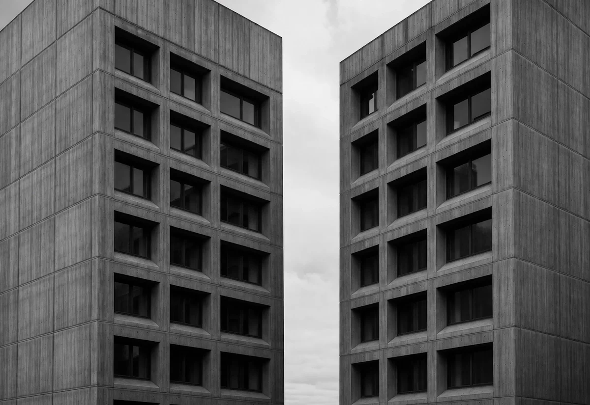 Two separated concrete tower blocks — the gap between AI adoption and operational readiness.