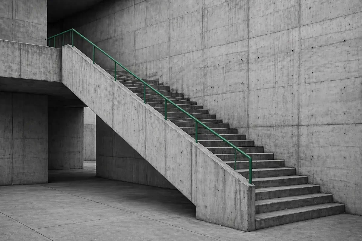 Concrete staircase connecting two levels with a green-accented handrail — what changes when the workflow is fixed