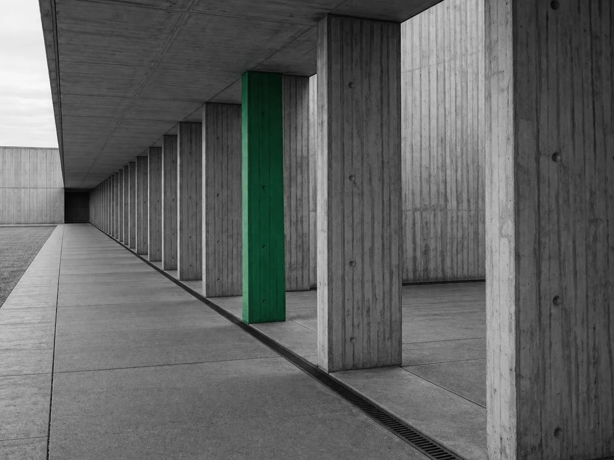 Concrete corridor with repeating columns — building operational structure before AI.