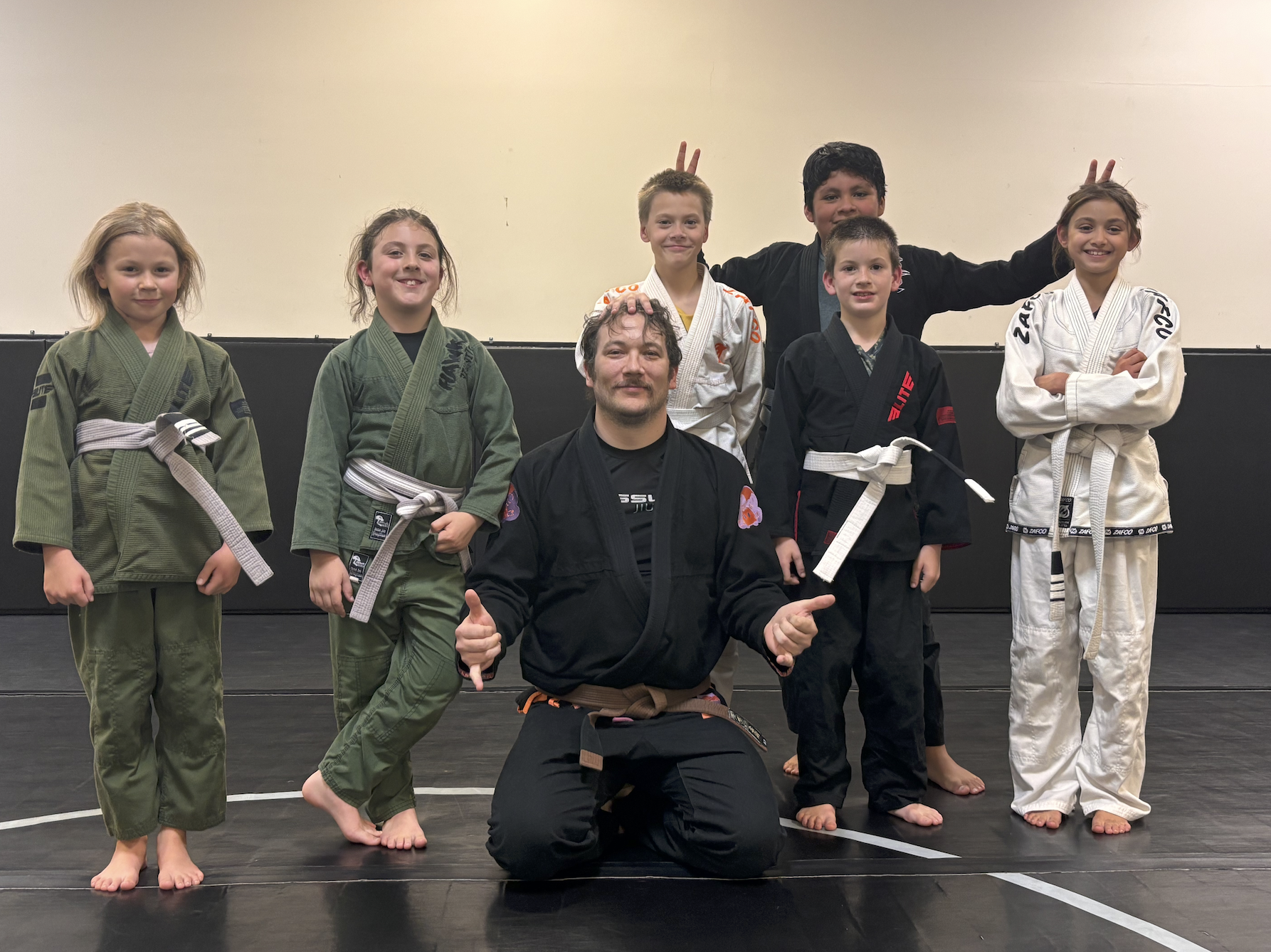 Students posing with coach Matt after Kids Gi Class