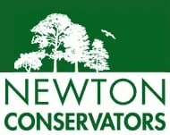 Logo of Newton Conservators featuring a large tree and the text 'Newton Conservators' in green and white.