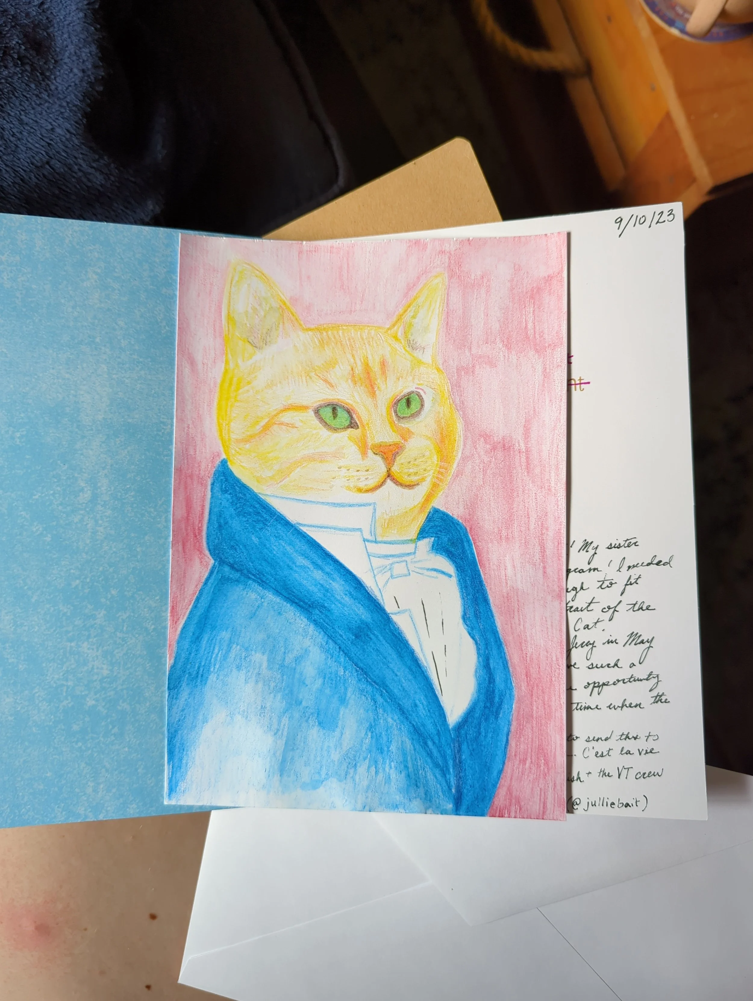 Colorful drawing of a cat with green eyes dressed in a blue coat and white shirt, set against a pink background.