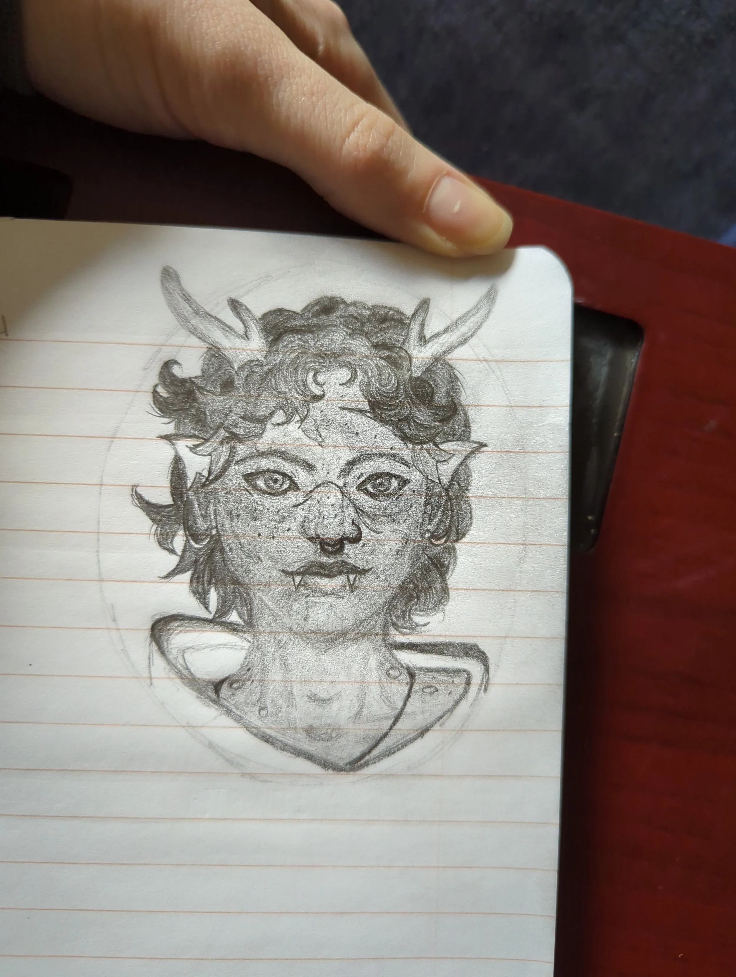 Pencil sketch of a fantasy creature with human and animal features, including horns, pointed ears, and sharp teeth, on lined notebook paper.