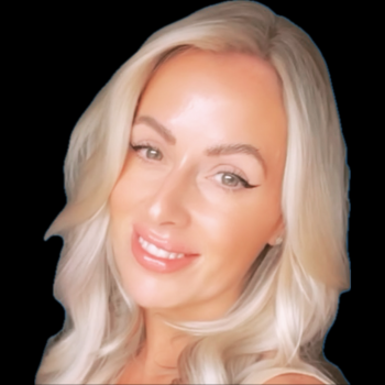 A woman with blonde hair, light makeup, and a slight smile, looking at the camera against a black background.