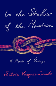 Book cover titled 'In the Shadow of the Mountain: A Memoir of Courage' by Silvia Vasquez-Lavado, with a decorative knot design on a dark blue background.