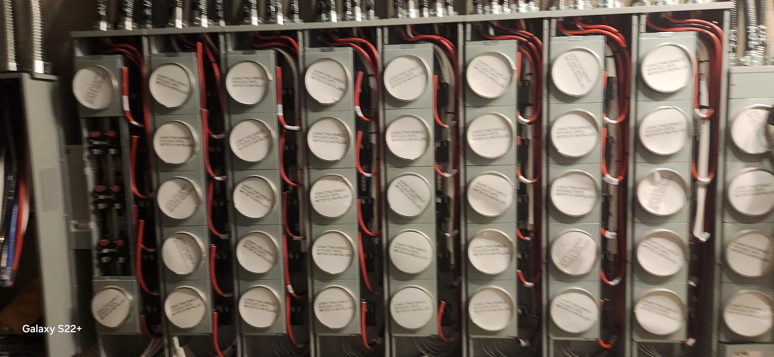 A close-up view of a lithium-ion battery bank with multiple cells connected by red and black wires.