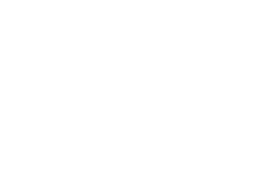 Close-up of a speedometer gauge with a needle pointing to high speed.