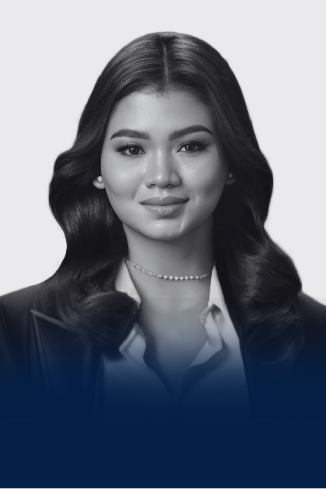 Black and white portrait of a young woman with wavy hair, wearing a collared shirt, a blazer, and a pearl necklace.