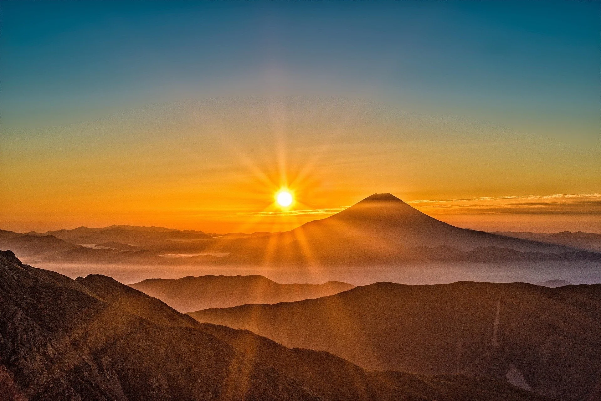  mountain with orange sunrise behind 