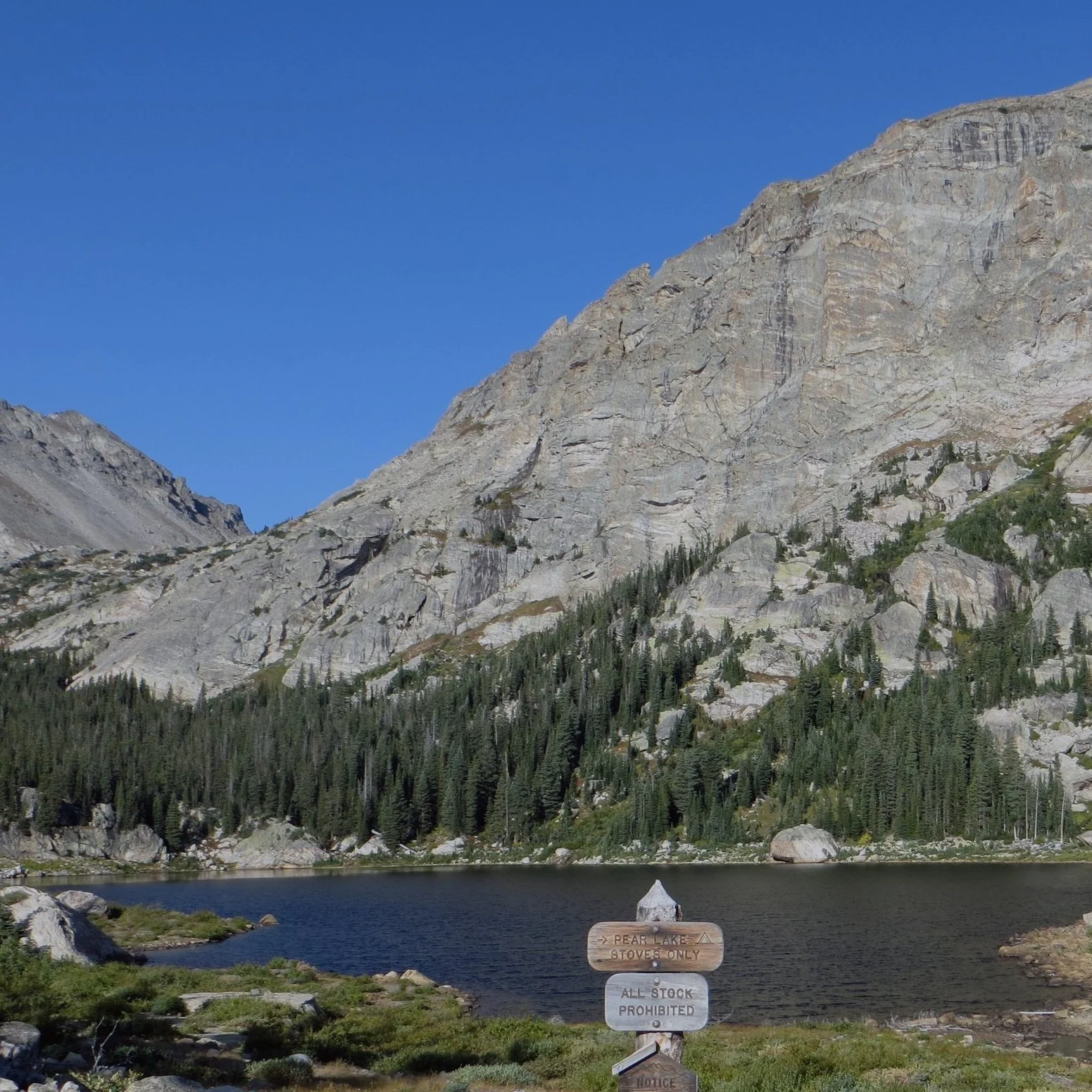 Pear Lake is shown against a bright blue sky