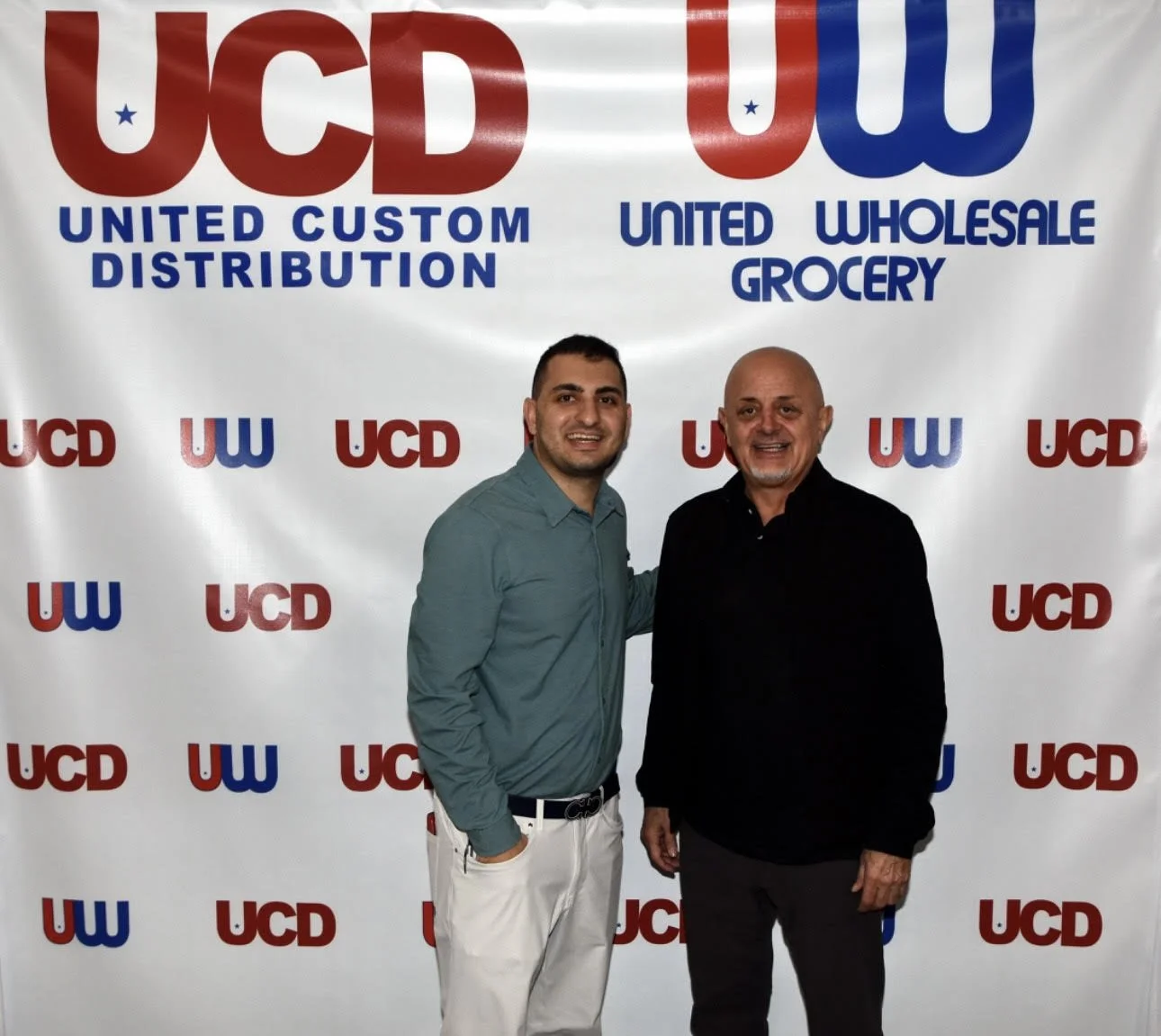 Father and son leaders of United Custom Distribution standing together.