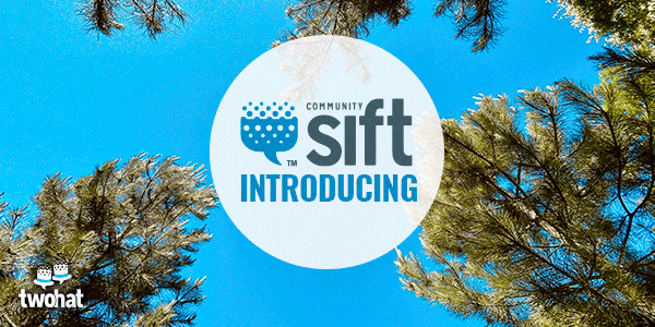 A promotional sign for Community Sift hanging among trees, with a blue sky in the background.