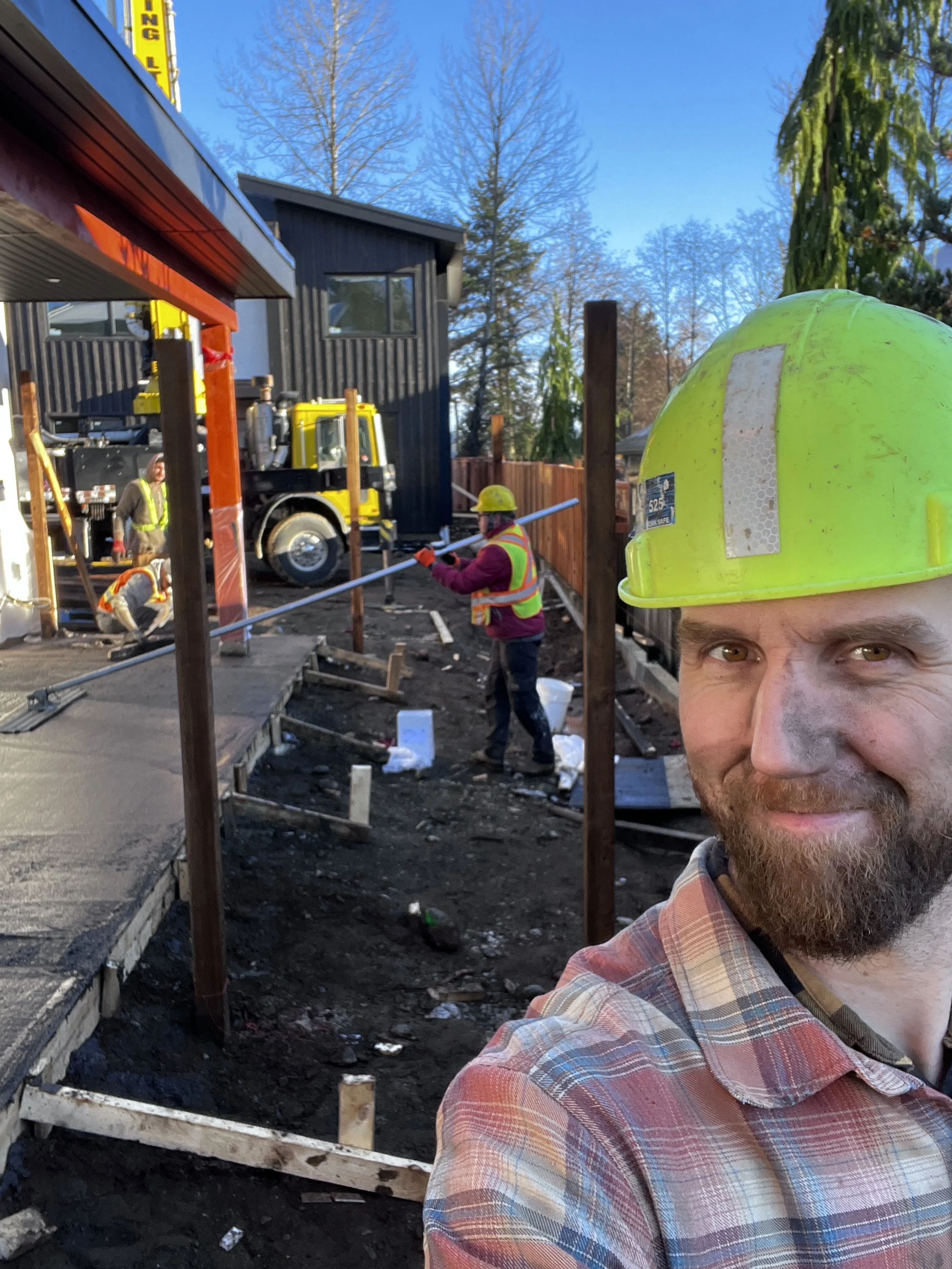 Red Seal carpenters and developers George Slomp and Peter Bain working hands-on at the Nine Peaks construction site in Courtenay, BC, ensuring builder-direct quality control.