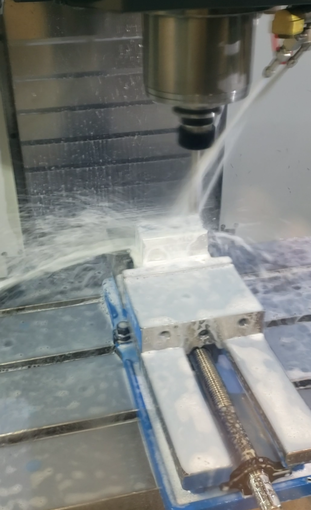 Close-up of a CNC machine milling a metallic workpiece in a workshop.