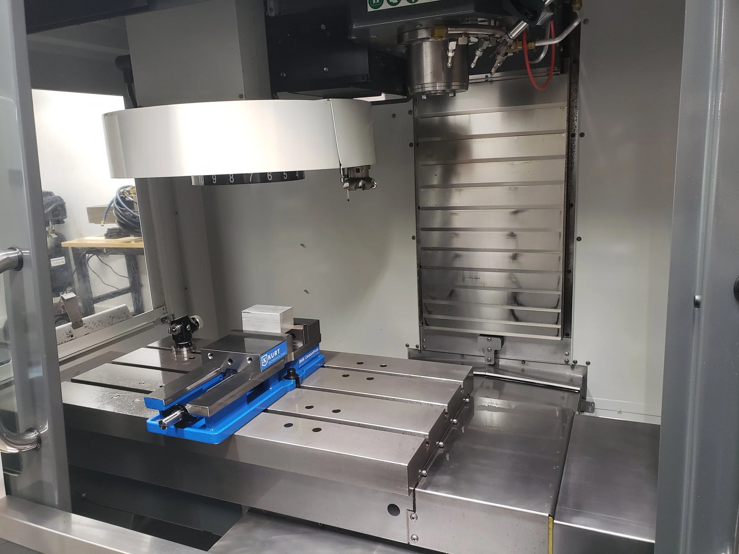 X-ray inspection machine with a black and blue mechanical component and a white block inside.