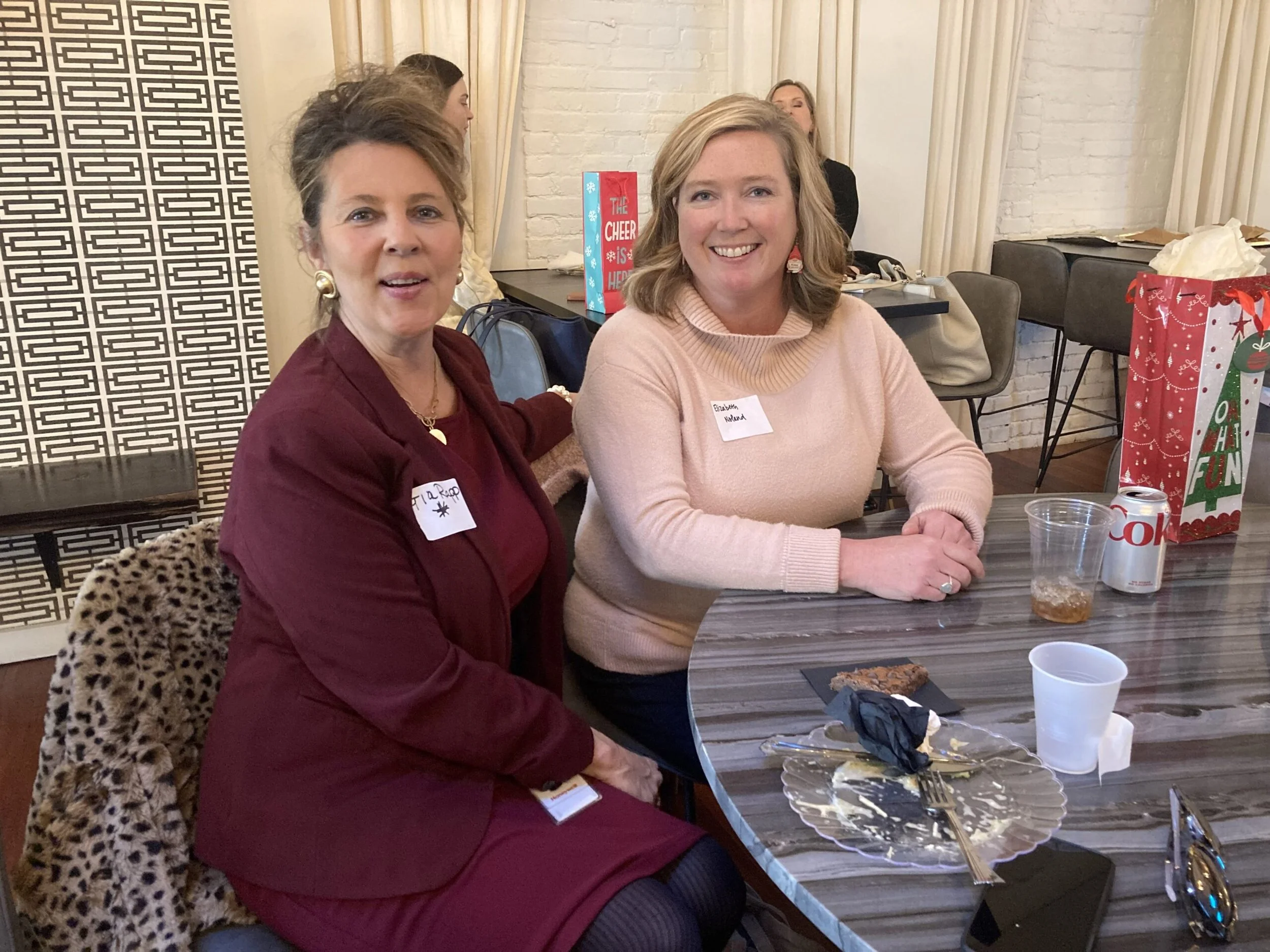 2 women with nametags sitting at table