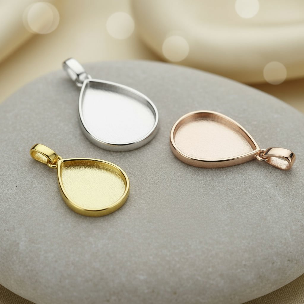 Gold, rose gold, and silver memorial ring settings arranged on a marble surface, shown empty before resin or inclusions are added.