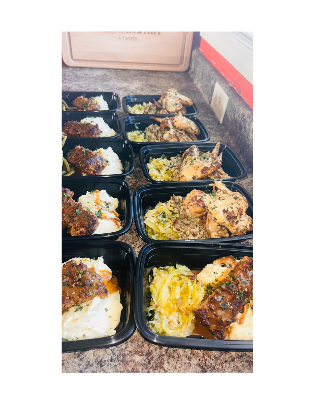 Multiple meal containers filled with mashed potatoes, meatloaf, and cooked vegetables arranged on a kitchen counter.