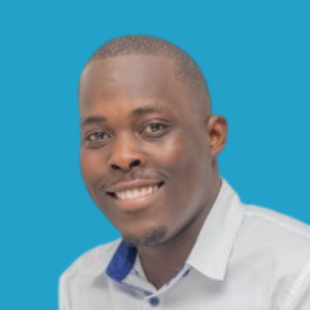 Close-up of a man with a smile, wearing a light-colored shirt and a blue and white collar, against a solid blue background.