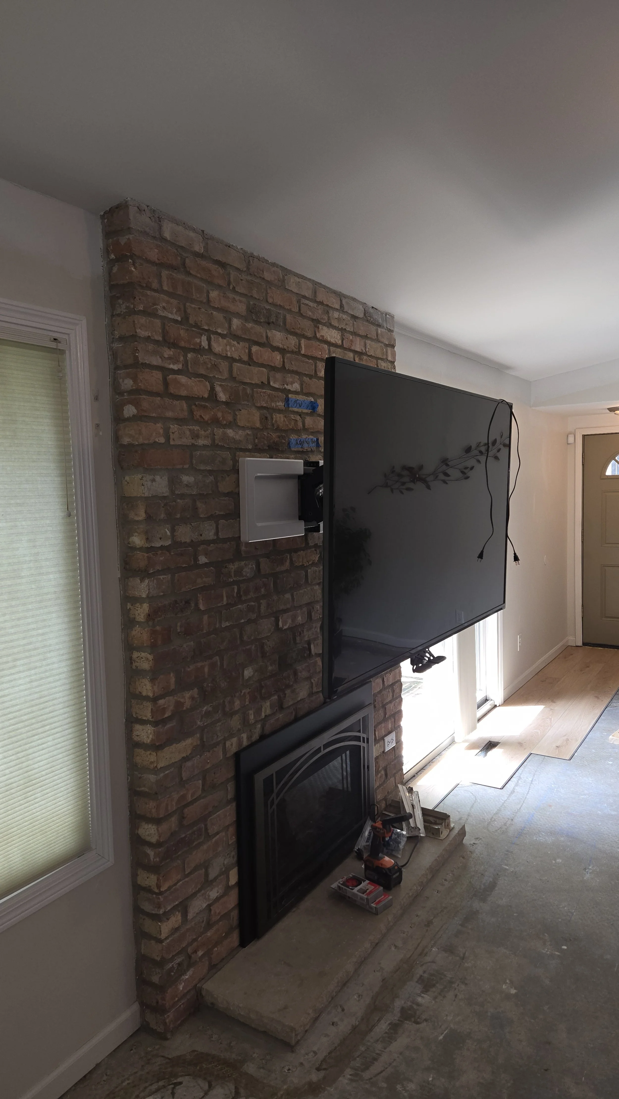 Hung Flatscreen Television On A Brick Facade