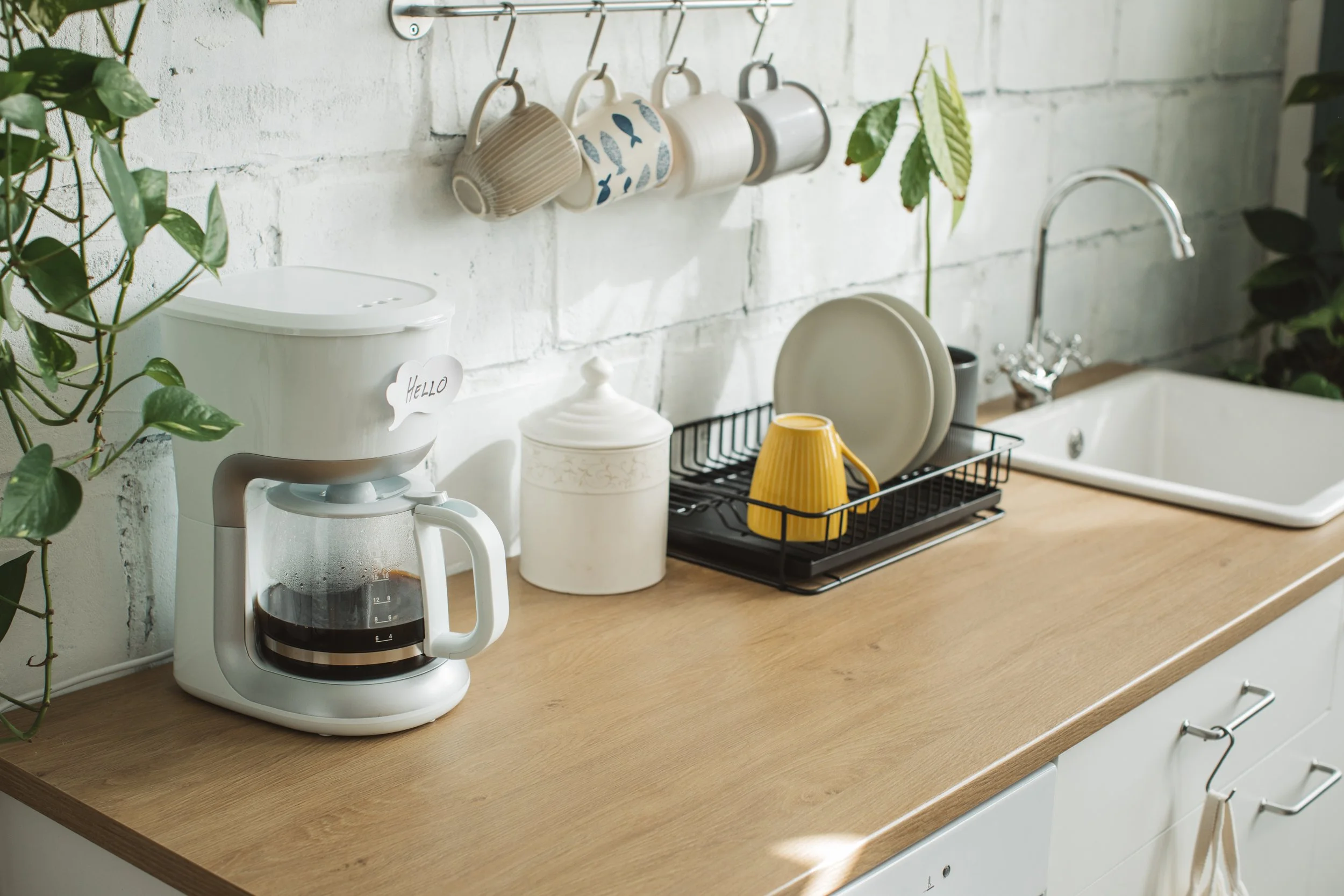 clean kitchen with coffee maker and cups
