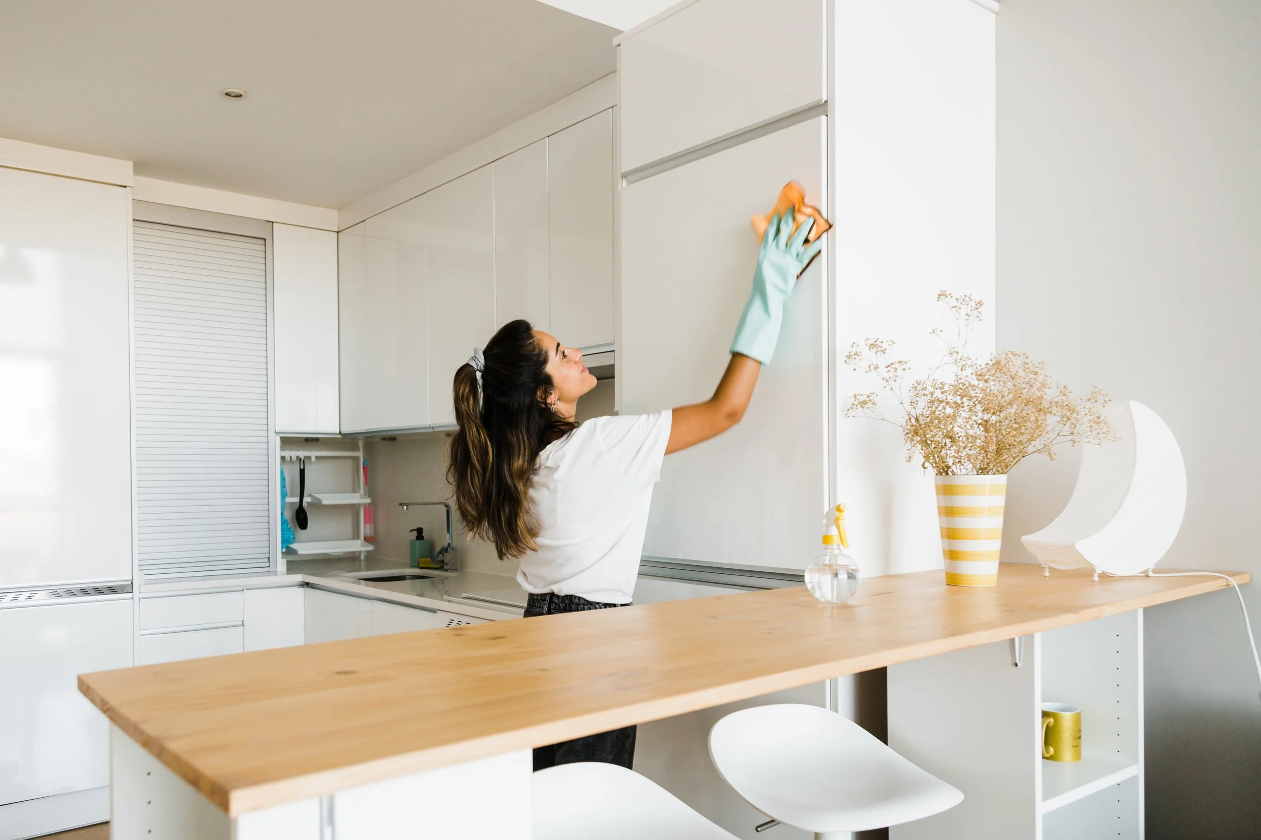 woman cleaning the cupboards
