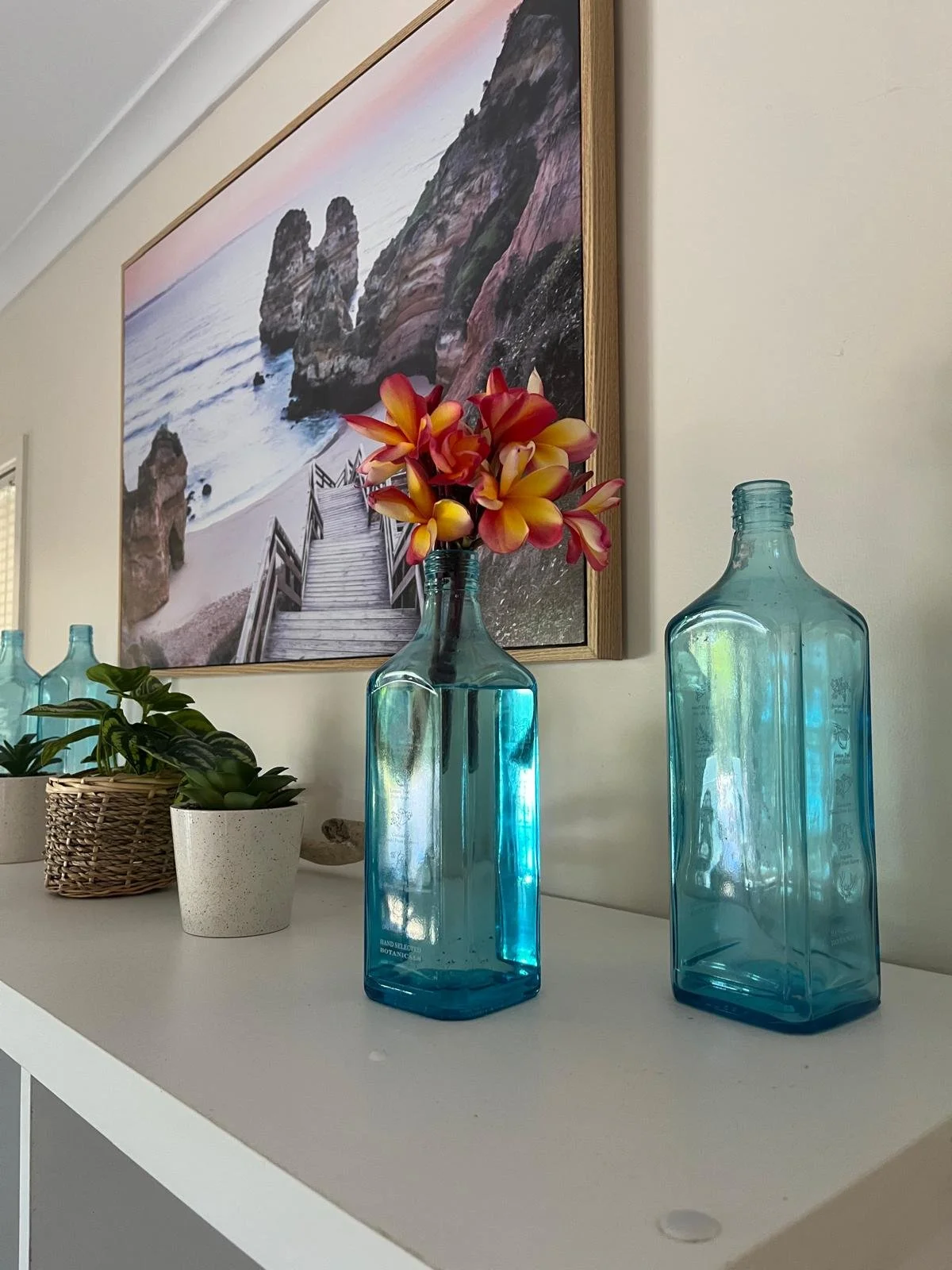 Frangipani flowers in a beach bottle