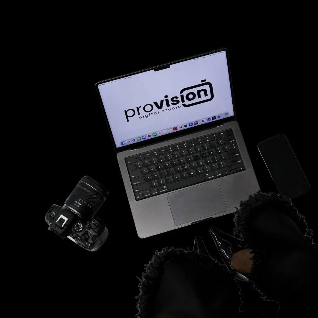 Woman holding a book labeled "Creative Strategy and the Business of Design" in red letters that covers her face as she sits in a chair 