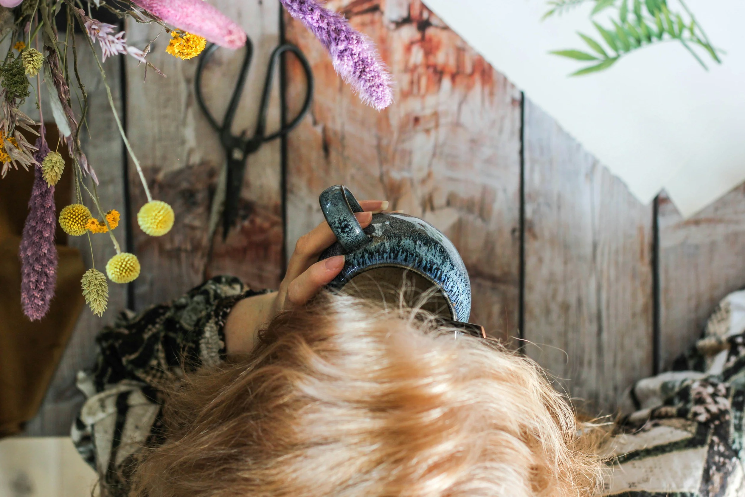 Child running and playing with a colorful kite in a green outdoor field