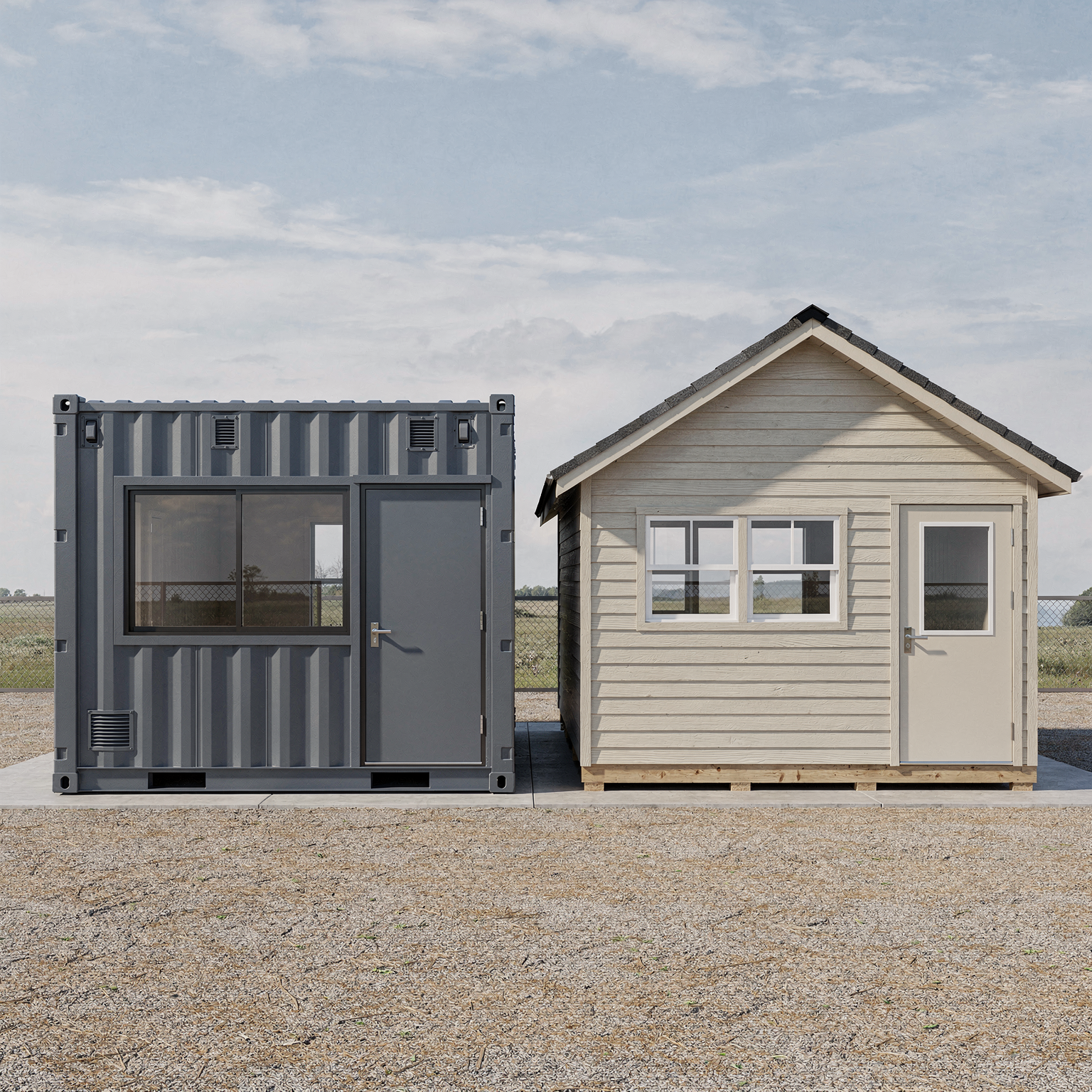 A small beige wooden house with a door, two windows, and a black roof, next to a dark gray shipping container that has a door and a window, on a concrete pad with gravel in the foreground.
