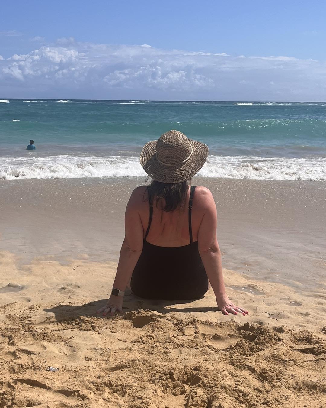 Woman relaxing on the beach during a stress-free vacation planned by a travel agent with no research or planning required