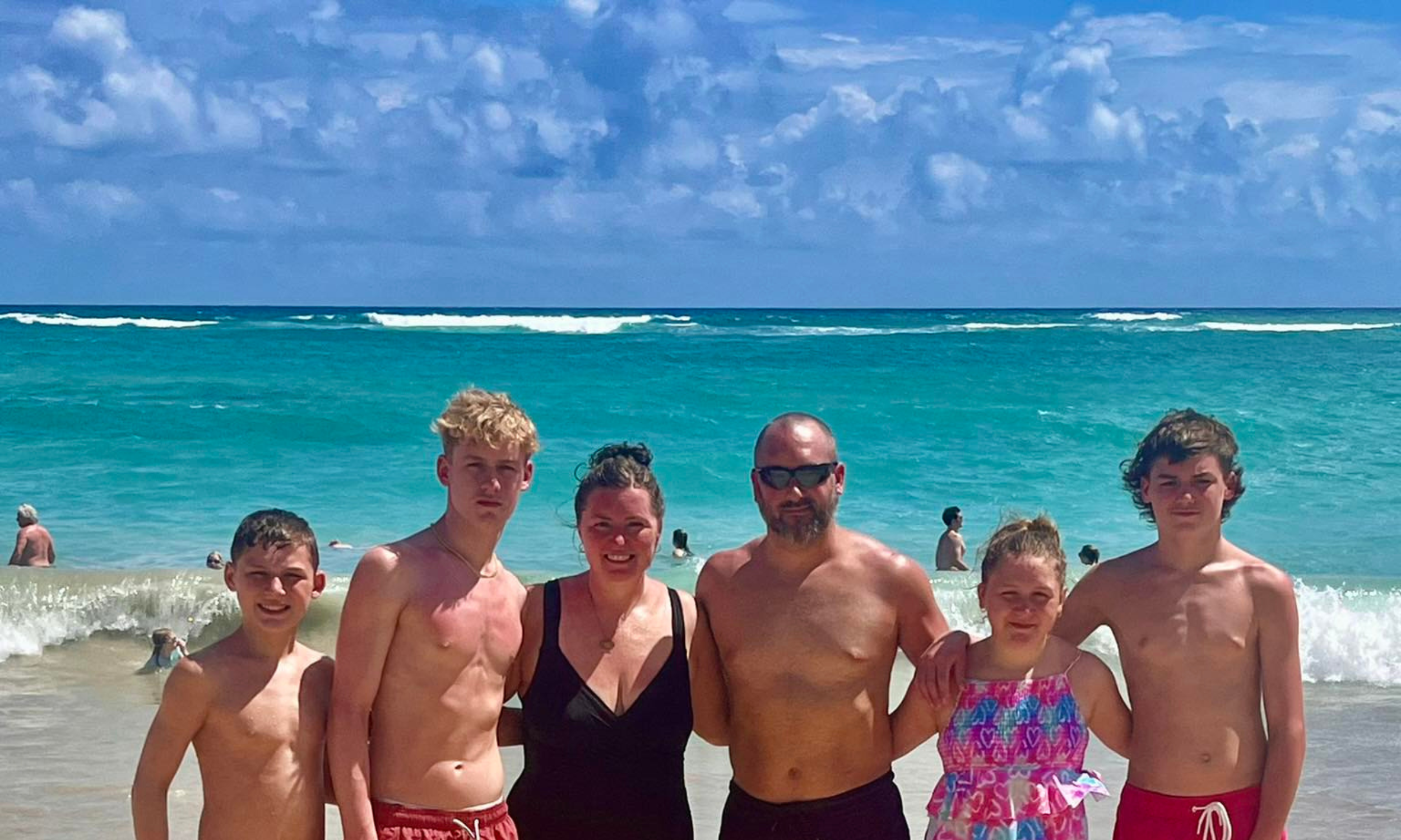 Family enjoying a beach vacation planned with custom travel services by a Northwest Indiana travel agent.
