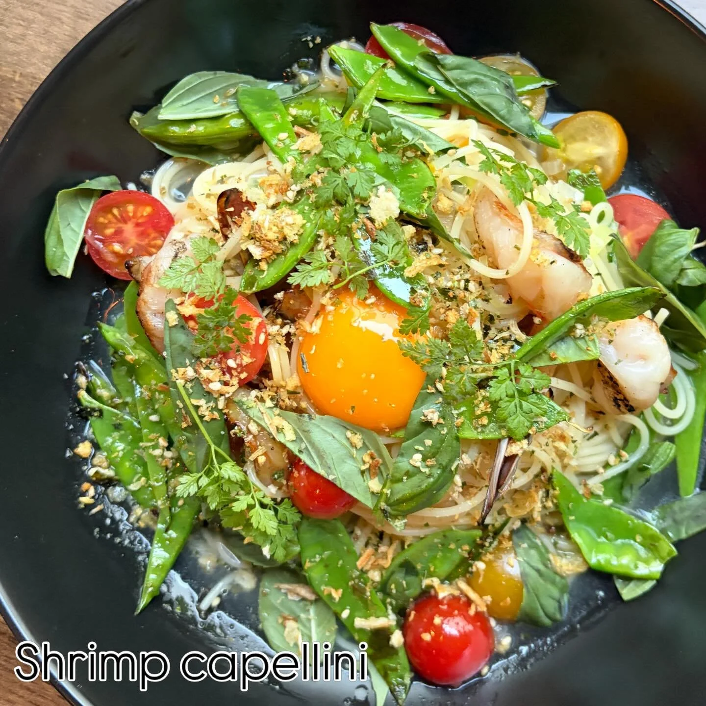 New menu item. Grilled shrimp and capellini pasta with sesame charred snow peas, cherry tomatoes, dashi-ginger brodo, egg yolk, basil.