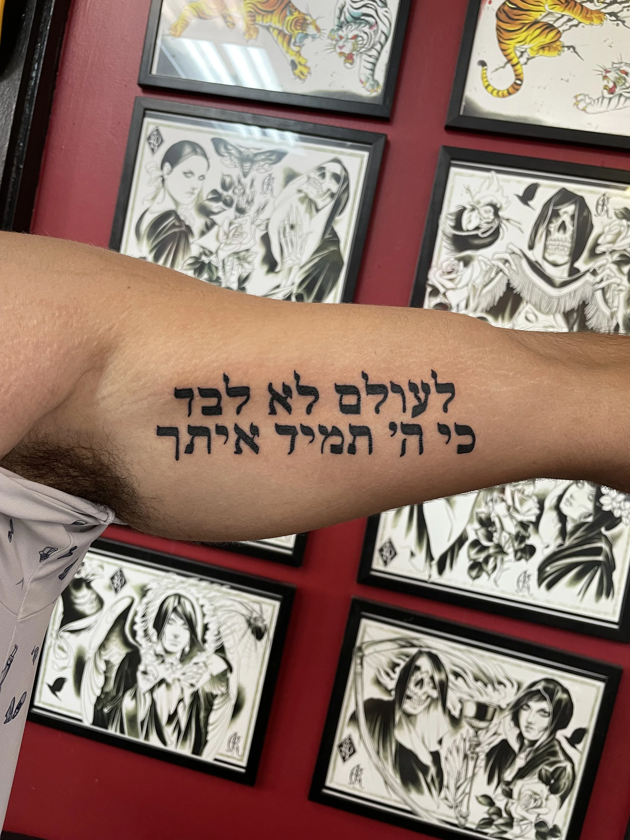 Bold black Hebrew script forearm tattoo featuring a two-line meaningful quote in traditional Hebrew lettering, custom tattoo by Nick at Big Kahuna Tattoo in Boca Raton, FL.