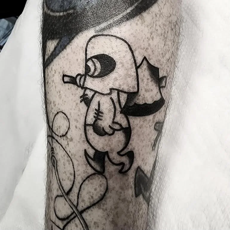 Black and grey bold traditional leg tattoo featuring a cartoon executioner holding an axe, part of a larger leg sleeve, custom tattoo by Brandon Perez at Big Kahuna Tattoo in Boca Raton, FL