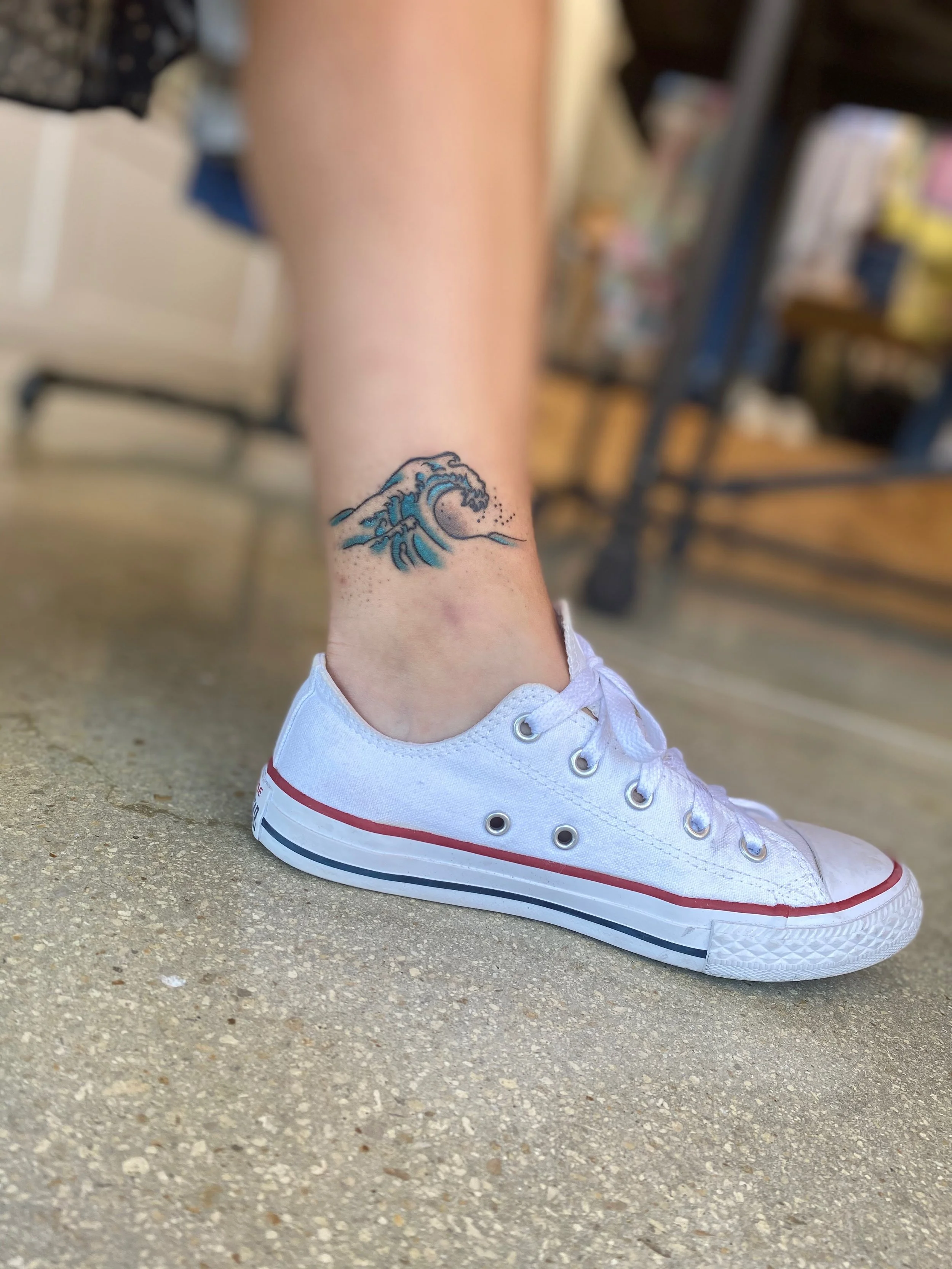 Small color ankle tattoo featuring a Japanese style ocean wave with blue and teal tones, custom tattoo by Nick at Big Kahuna Tattoo in Boca Raton, FL.
