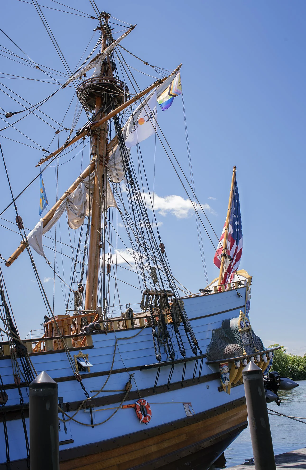 Kalmar Nyckel tall ship flying American, rainbow Pride and Discover flags.