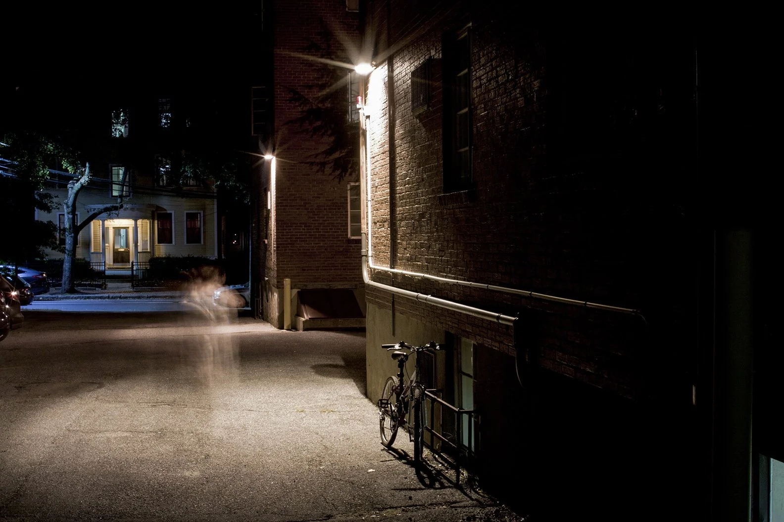 Night scene long exposure photo with a ghostly blur of a person.