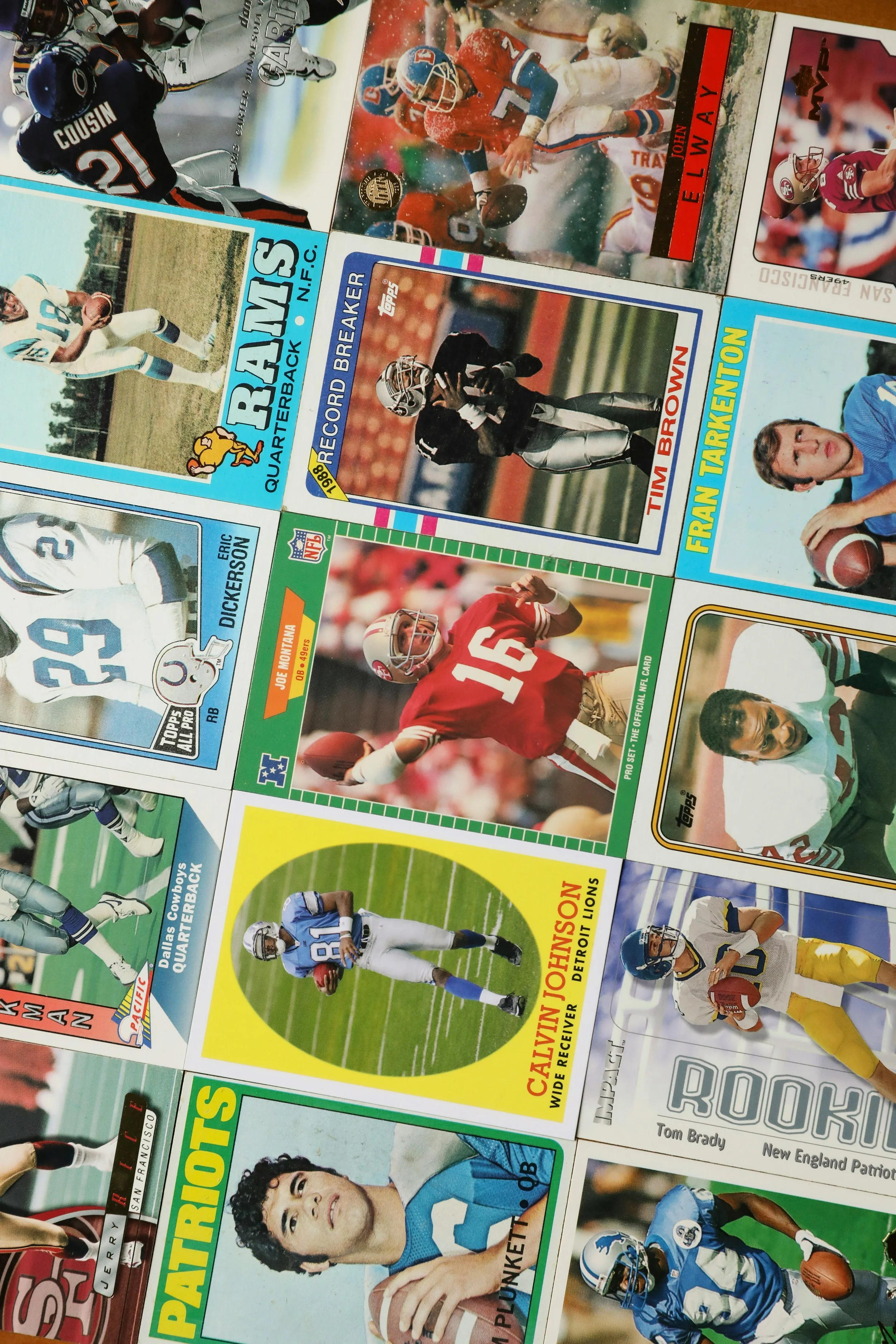 Collection of vintage sports trading cards featuring American football and basketball players with colorful backgrounds and player action images.