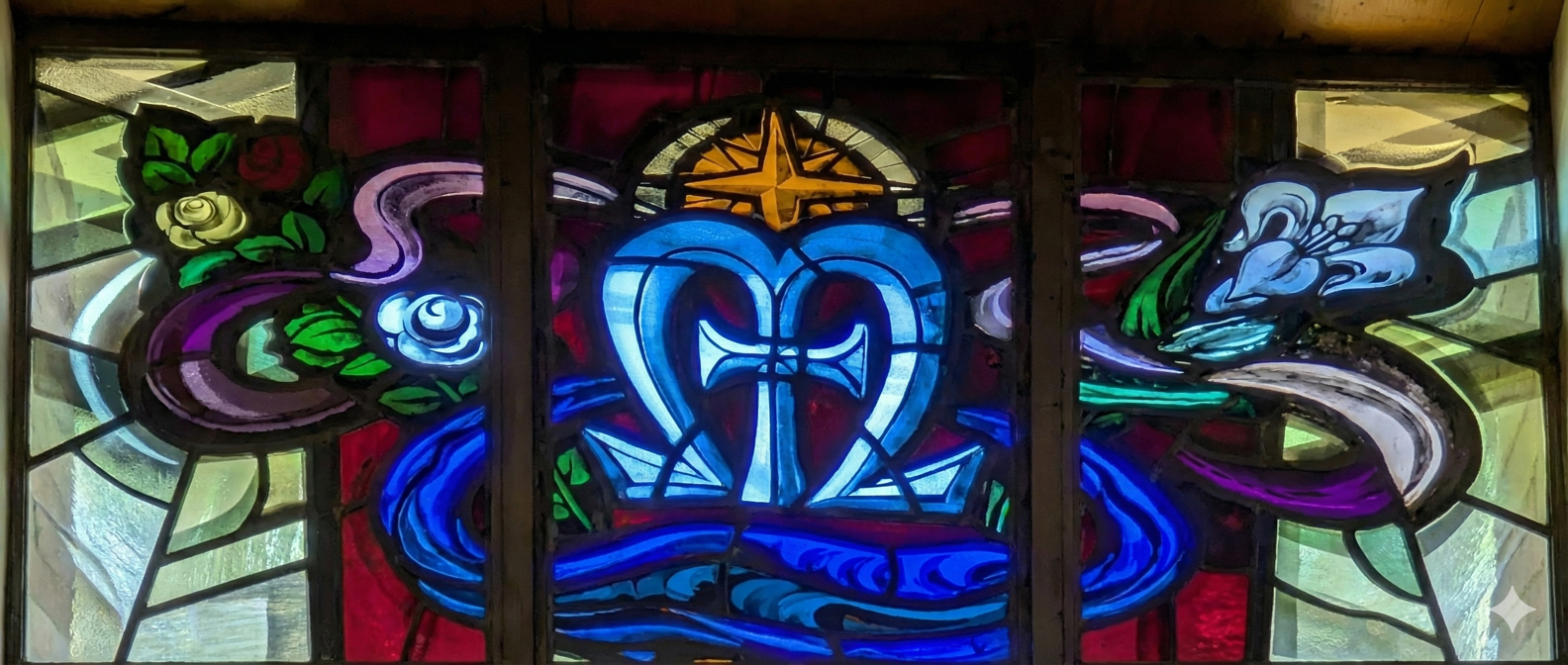 Colorful stained glass window with a heart, cross, and flowers