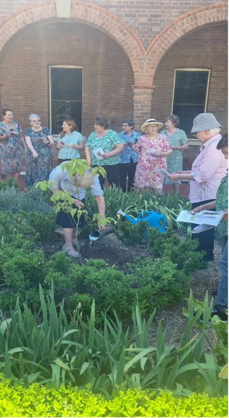 Sisters and colleagues plant a tree in memory of their dear friend, Valerie.