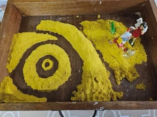 A child's art therapy sand sculpture featuring St Michael the Archangel.